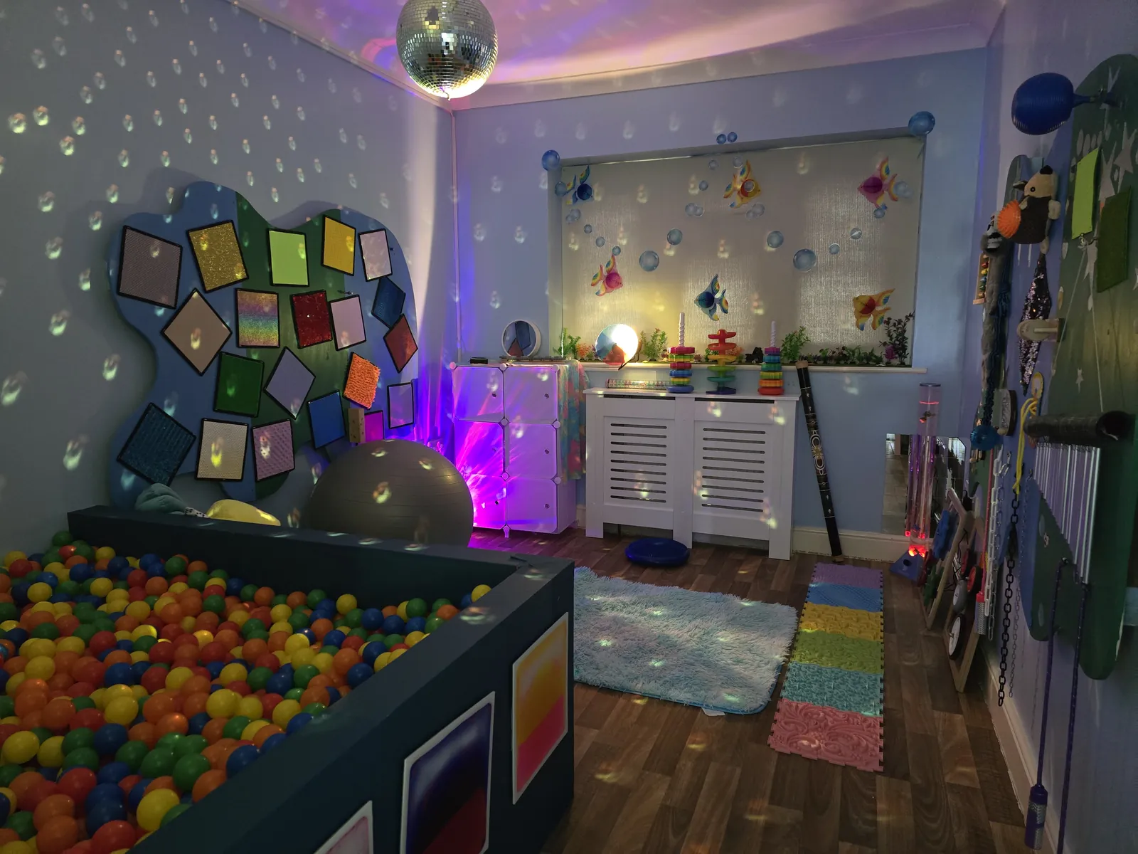 The sensory room at Robinson House with a large ball pool, texture wall and sensory lighting